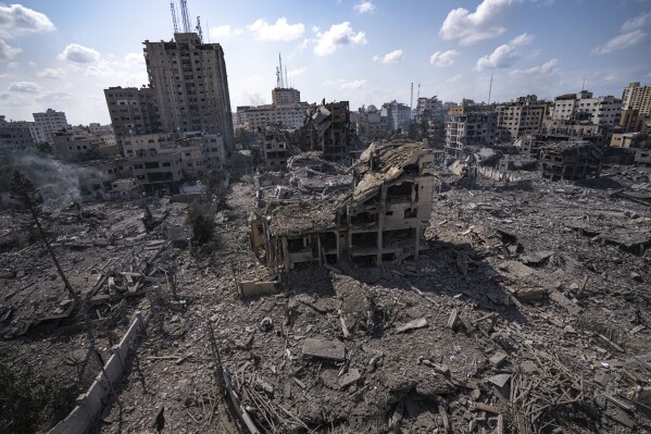 A neighborhood in Gaza City hit by an Israeli airstrike lies in rubble, Tuesday, Oct. 10, 2023. Israel has launched intense airstrikes in Gaza after the territory's militant rulers carried out an unprecedented attack on Israel Saturday, killing over 1,000 people and taking captives. Hundreds of Palestinians have been killed in the airstrikes. (AP Photo/Fatima Shbair)